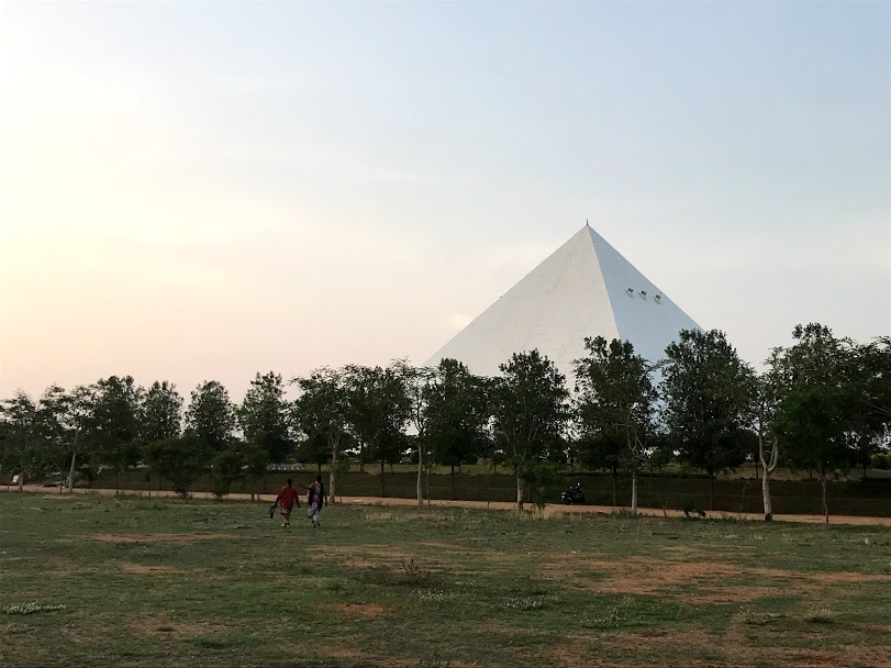 Pyramid rising above the tree line across the campus grounds