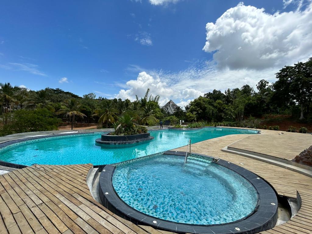 Starlight pool deck with the Maitreya Buddha Pyramid rising beyond the treeline