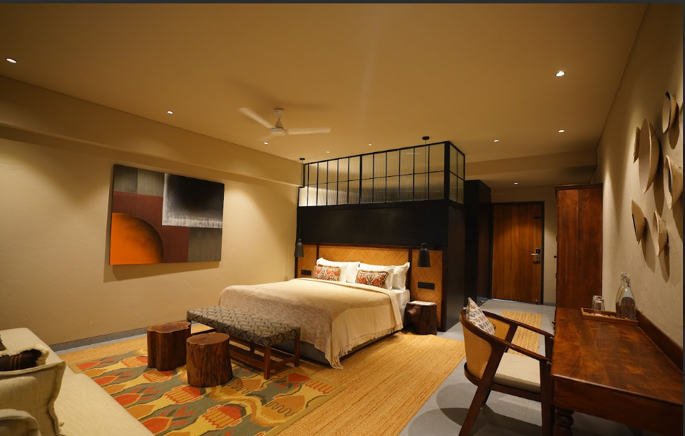 Guest bedroom with woven headboard, jute rug, and warm neutral palette