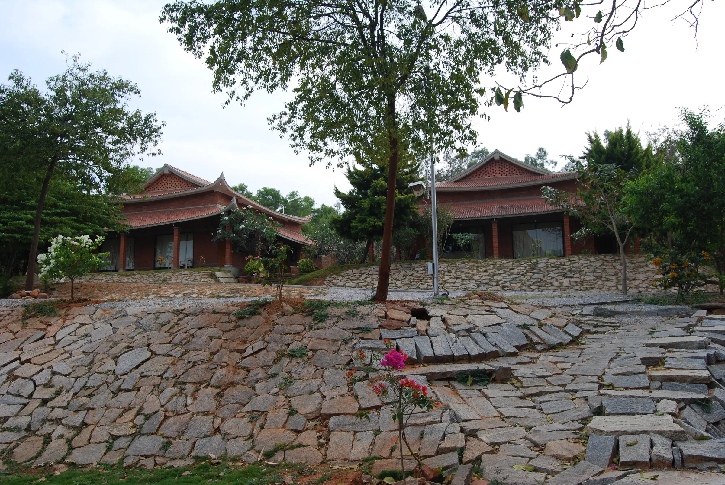 Irregular stone paving before the pagoda-roofed cottages
